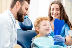 Kind sitzt auf einem Behandlungsstuhl beim Zahnarzt