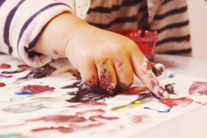 Kind malt mit den Händen