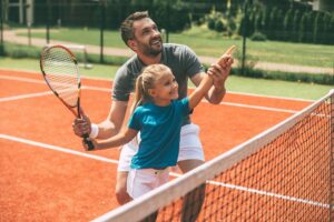 Vater und Tochter spielen Tennis
